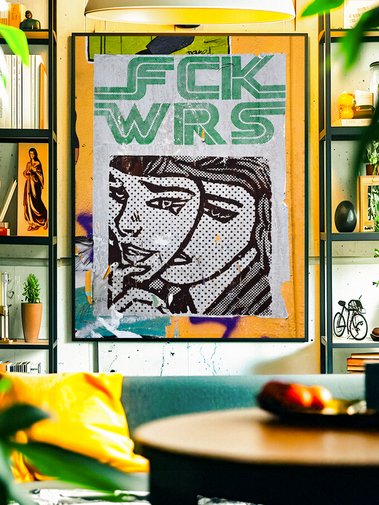 A bold anti-war pop art poster reading “FCK WRS” hangs in a stylish living room. The artwork blends vintage comic-style graphics with modern typography, surrounded by plants, books, and warm lighting that create a cozy yet vibrant interior atmosphere.