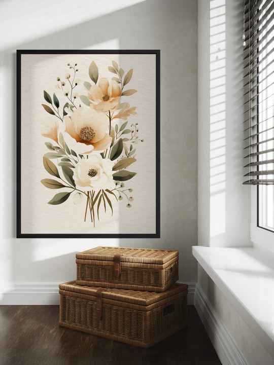 A framed botanical floral print hangs on a light textured wall in a bright interior. The artwork features soft beige and cream flowers with green leaves in a minimal, elegant composition. Sunlight falls through window blinds, casting natural shadows across the wall and frame. Below the artwork sit two woven wicker storage baskets, adding warmth and texture to the clean, modern space.