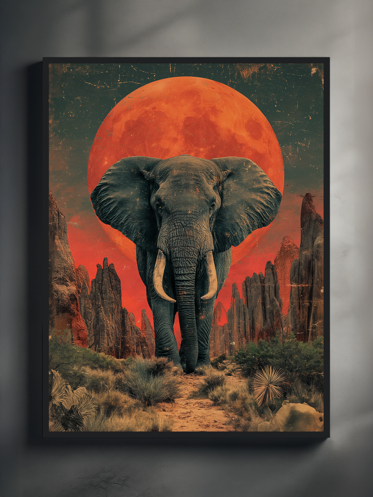 Poster of a powerful elephant standing on a desert path, framed by dramatic rock formations and desert plants, with a vivid red full moon dominating the sky in a surreal, dreamlike composition.