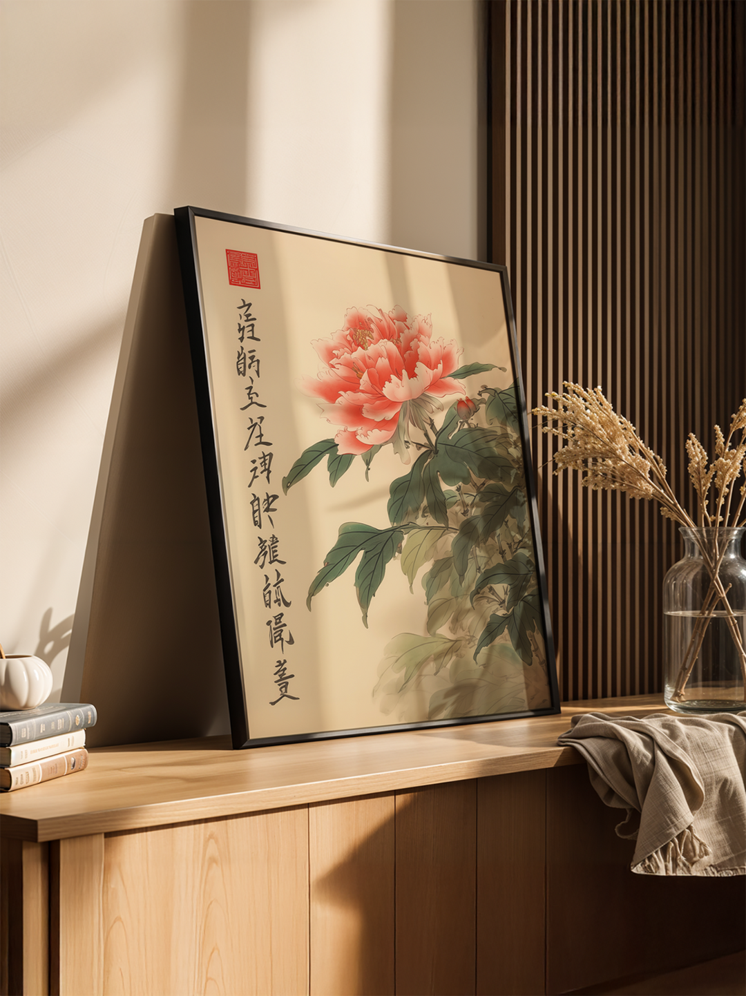 A traditional Chinese painting of a blooming pink peony with elegant calligraphy, framed and leaning against a wall in a sunlit minimalist interior. The artwork is styled with natural wood elements, a linen cloth, and dried flowers in a glass vase, creating a serene and refined aesthetic. Ideal for Asian-inspired or zen-style home decor.