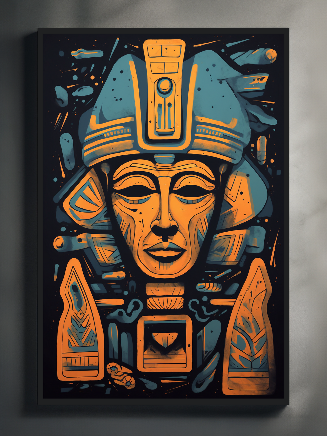 A modern graphic art poster featuring a stylized pharaoh head in vibrant blue and orange hues. The design includes geometric shapes and symbolic details in a symmetrical layout, set against a black background with sharp contrast, all framed in a sleek black frame on a neutral wall.