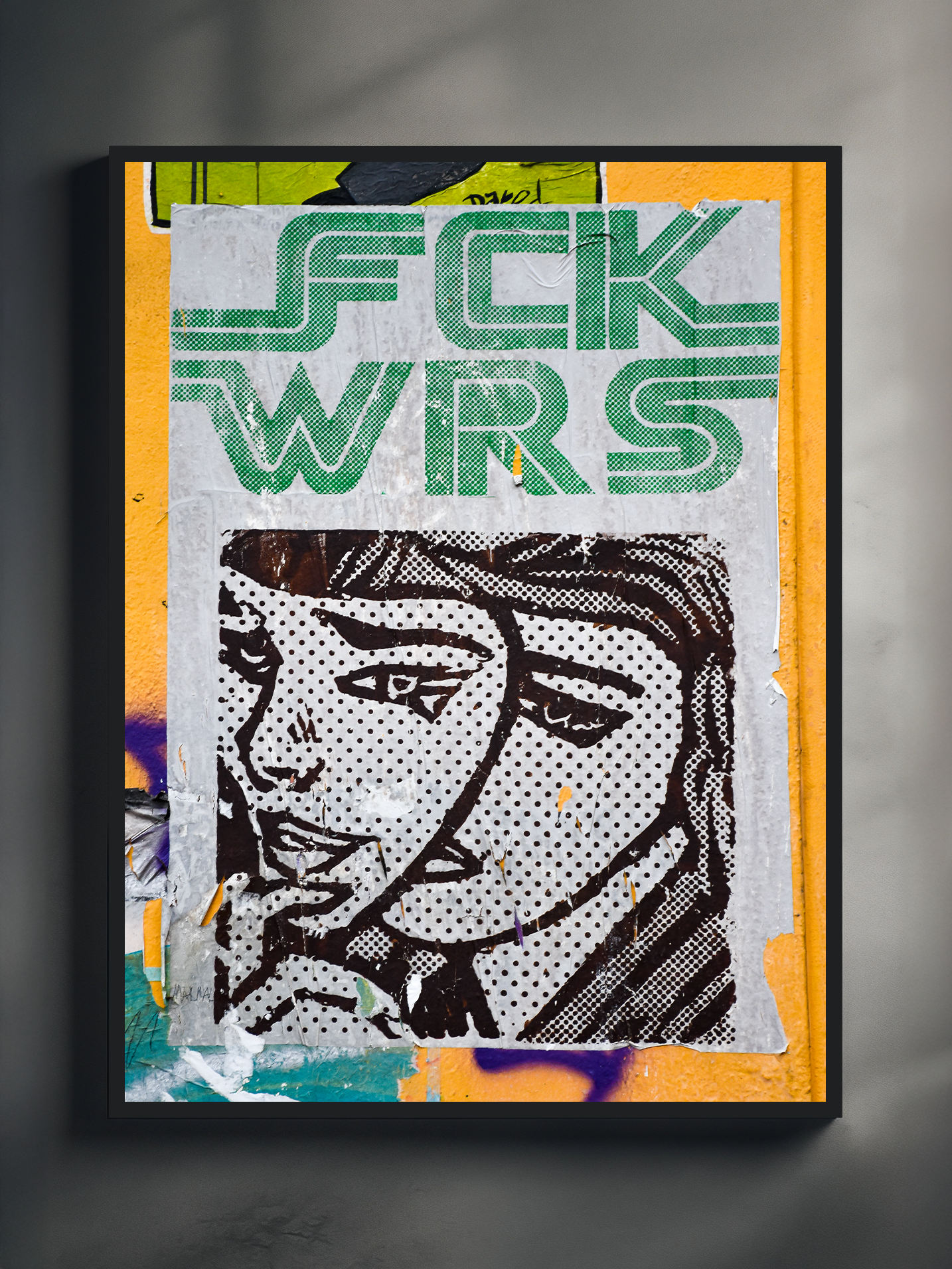 Framed street art-inspired poster featuring a black-and-white comic-style illustration of a couple, layered with bold green text reading “FCK WRS” in a retro font. The artwork mimics torn paper textures and urban sticker aesthetics, creating a raw, expressive visual typical of modern pop and street art design.