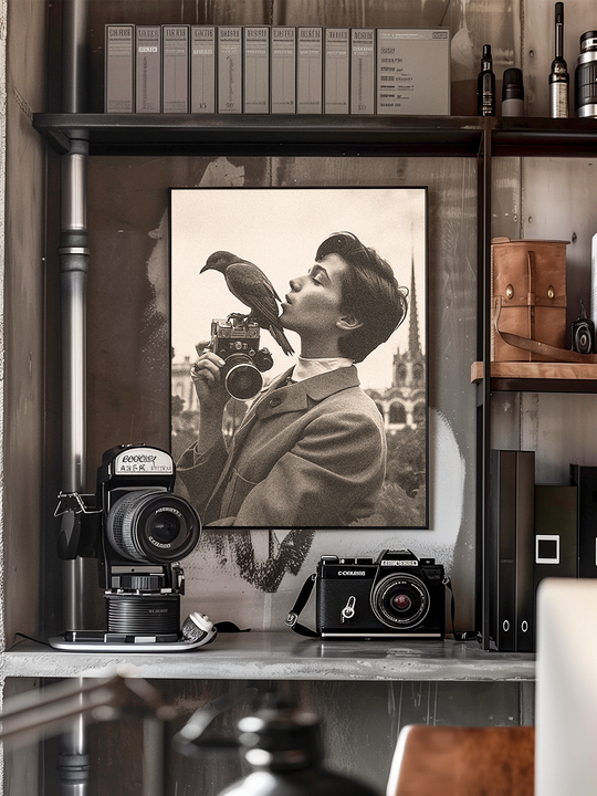 A realistic photograph of an industrial-style shelf filled with vintage cameras, leather accessories, and archival boxes. At the center is a large black-and-white portrait of a stylish person holding a camera while a bird perches on it, creating an artistic focal point. The scene is richly detailed with photography equipment, organized files, and warm lighting, evoking a nostalgic, creative studio atmosphere perfect for interior design inspiration and photography enthusiasts.